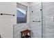Tiled shower with modern fixtures, a built-in seat, and a window for light at 4493 E Desert Sands Dr, Chandler, AZ 85249