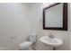 Powder room with a framed mirror, vessel sink, and modern fixtures at 5026 E Sunstone Dr, San Tan Valley, AZ 85143