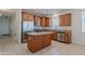 Spacious kitchen featuring wood cabinets, stainless steel appliances, granite countertops, and a center island at 5026 E Sunstone Dr, San Tan Valley, AZ 85143