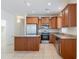 Spacious kitchen featuring wood cabinets, stainless steel appliances, granite countertops, and a center island at 5026 E Sunstone Dr, San Tan Valley, AZ 85143