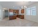 Spacious kitchen features stainless appliances, granite counters, wood cabinets, island, and tile floors at 5026 E Sunstone Dr, San Tan Valley, AZ 85143
