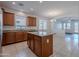 Open kitchen with granite countertops, island, stainless appliances, and tile flooring at 5026 E Sunstone Dr, San Tan Valley, AZ 85143