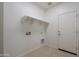Well-lit laundry room features practical shelving for storage and neutral tile flooring at 5026 E Sunstone Dr, San Tan Valley, AZ 85143