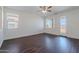 Spacious living room with wood-look floors, large windows, and a glass door to the backyard at 5026 E Sunstone Dr, San Tan Valley, AZ 85143