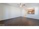 View of the open-concept living space with adjacent kitchen area and dark wood flooring at 5026 E Sunstone Dr, San Tan Valley, AZ 85143