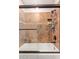 Tiled bathtub/shower featuring a sliding glass door and bronze fixtures at 5402 E Larkspur Dr, Scottsdale, AZ 85254