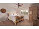 Cozy bedroom with natural wood bed frame, window with shutters, and built-in cabinet at 5402 E Larkspur Dr, Scottsdale, AZ 85254