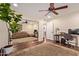 Comfortable bedroom featuring a ceiling fan, hardwood floors, mirrored closet, and attached bathroom at 5402 E Larkspur Dr, Scottsdale, AZ 85254