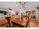 Inviting dining area with rustic table and light fixture, seamlessly flowing to living room at 5402 E Larkspur Dr, Scottsdale, AZ 85254