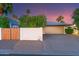 Attached garage with a side gate on a home with desert landscaping at 5402 E Larkspur Dr, Scottsdale, AZ 85254
