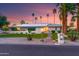 Charming home featuring desert landscaping, solar panels, and beautiful sunset lighting at 5402 E Larkspur Dr, Scottsdale, AZ 85254