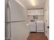 Laundry area featuring appliances, tile floor and built-in shelving at 5402 E Larkspur Dr, Scottsdale, AZ 85254