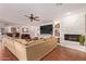 Bright living room features an inviting layout, cozy sectional, and stone fireplace at 5402 E Larkspur Dr, Scottsdale, AZ 85254