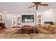 Open concept living room features a brick fireplace, large sectional, and stylish furnishings at 5402 E Larkspur Dr, Scottsdale, AZ 85254