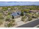Stunning aerial view of the home showcasing the desert landscape and mountain views at 7486 E Bajada Rd, Scottsdale, AZ 85266