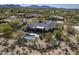 Aerial view of the estate showing a backyard pool, desert landscaping, mountain views, and neighborhood at 7486 E Bajada Rd, Scottsdale, AZ 85266
