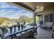 Covered patio area overlooking a private backyard oasis complete with a pool, desert landscaping, and seating at 7486 E Bajada Rd, Scottsdale, AZ 85266