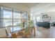 Bright dining room features natural light, glass table and view to the outdoor pool at 7486 E Bajada Rd, Scottsdale, AZ 85266