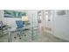 Bright office space with glass desk and view to the entryway with french doors at 7486 E Bajada Rd, Scottsdale, AZ 85266