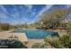 Backyard swimming pool surrounded by desert landscaping offers a refreshing escape with clear blue water at 7486 E Bajada Rd, Scottsdale, AZ 85266