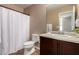 The bathroom features a bathtub shower combination and dark wooden cabinets at 7722 W Pipestone Pl, Phoenix, AZ 85035