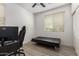 A bedroom featuring a sleeper sofa, desk, monitor and ceiling fan at 7722 W Pipestone Pl, Phoenix, AZ 85035