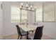 Bright dining area featuring modern lighting, a sleek table with seating for four, creating an ideal space for meals at 7722 W Pipestone Pl, Phoenix, AZ 85035