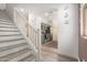 An entryway to the kitchen area is complimented by light colored stairway and walls at 7722 W Pipestone Pl, Phoenix, AZ 85035