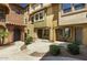 Charming townhouse exteriors featuring landscaped walkways connecting residences, creating a welcoming community atmosphere at 7722 W Pipestone Pl, Phoenix, AZ 85035