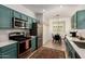 This kitchen features stainless steel appliances, light countertops, and cabinets with eat in dining area at 7722 W Pipestone Pl, Phoenix, AZ 85035