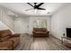 Comfortable living room featuring neutral decor, wood-look floors, ample seating, and easy access to the staircase at 7722 W Pipestone Pl, Phoenix, AZ 85035