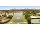 Scenic aerial view of a lakeside community featuring lush landscaping, tennis courts and mountain views at 8943 N 80Th Pl, Scottsdale, AZ 85258