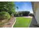 Serene backyard featuring lush landscaping, artificial turf, and a charming patio area with a relaxing hot tub at 8943 N 80Th Pl, Scottsdale, AZ 85258