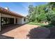 Charming backyard with large brick patio, grassy area, and landscaped surroundings at 8943 N 80Th Pl, Scottsdale, AZ 85258