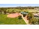 Aerial view of a park with a baseball field, playground, picnic benches and green grass at 8943 N 80Th Pl, Scottsdale, AZ 85258