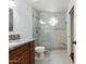 Modern bathroom featuring glass shower with seat, decorative window, and granite countertop vanity at 8943 N 80Th Pl, Scottsdale, AZ 85258