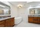 Bright bathroom with double vanity, granite countertops, soaking tub, and tile flooring at 8943 N 80Th Pl, Scottsdale, AZ 85258