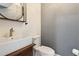 Stylish powder room featuring vessel sink on wood vanity and decorative round mirror at 8943 N 80Th Pl, Scottsdale, AZ 85258