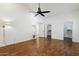 Spacious bedroom featuring hardwood floors, a ceiling fan, and large windows offering ample natural light at 8943 N 80Th Pl, Scottsdale, AZ 85258