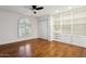 Bedroom with hardwood floors, built-in shelving, and closet; featuring a window providing natural light at 8943 N 80Th Pl, Scottsdale, AZ 85258