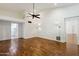 Bedroom with wood floors and bright lighting leads to an adjacent laundry room at 8943 N 80Th Pl, Scottsdale, AZ 85258