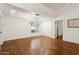 Dining area features wood floors, neutral walls, modern lighting, and bright window at 8943 N 80Th Pl, Scottsdale, AZ 85258