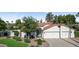 Beautiful home featuring a red tile roof, attached two car garage and a blue front door at 8943 N 80Th Pl, Scottsdale, AZ 85258
