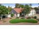 Attractive home featuring a red tile roof, an attached two car garage, mature trees, and lawn at 8943 N 80Th Pl, Scottsdale, AZ 85258