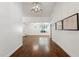 Hallway with wood floors, white walls and trim, leading to a naturally lit room at 8943 N 80Th Pl, Scottsdale, AZ 85258