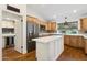 Bright kitchen featuring a center island, wood floors, stainless steel appliances, and a window at 8943 N 80Th Pl, Scottsdale, AZ 85258