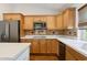 Well-lit kitchen features wood cabinets, stainless steel appliances, white countertop, and tile backsplash at 8943 N 80Th Pl, Scottsdale, AZ 85258