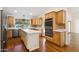 Bright kitchen with an island, wood cabinets, stainless steel appliances, and plenty of counter space at 8943 N 80Th Pl, Scottsdale, AZ 85258