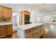 Well-lit kitchen with a center island, wood cabinets, stainless steel appliances, and wood floors at 8943 N 80Th Pl, Scottsdale, AZ 85258