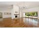 Spacious living room with wood floors, fireplace, and slider to the backyard at 8943 N 80Th Pl, Scottsdale, AZ 85258
